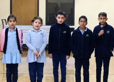 Students speaking during morning assembly
